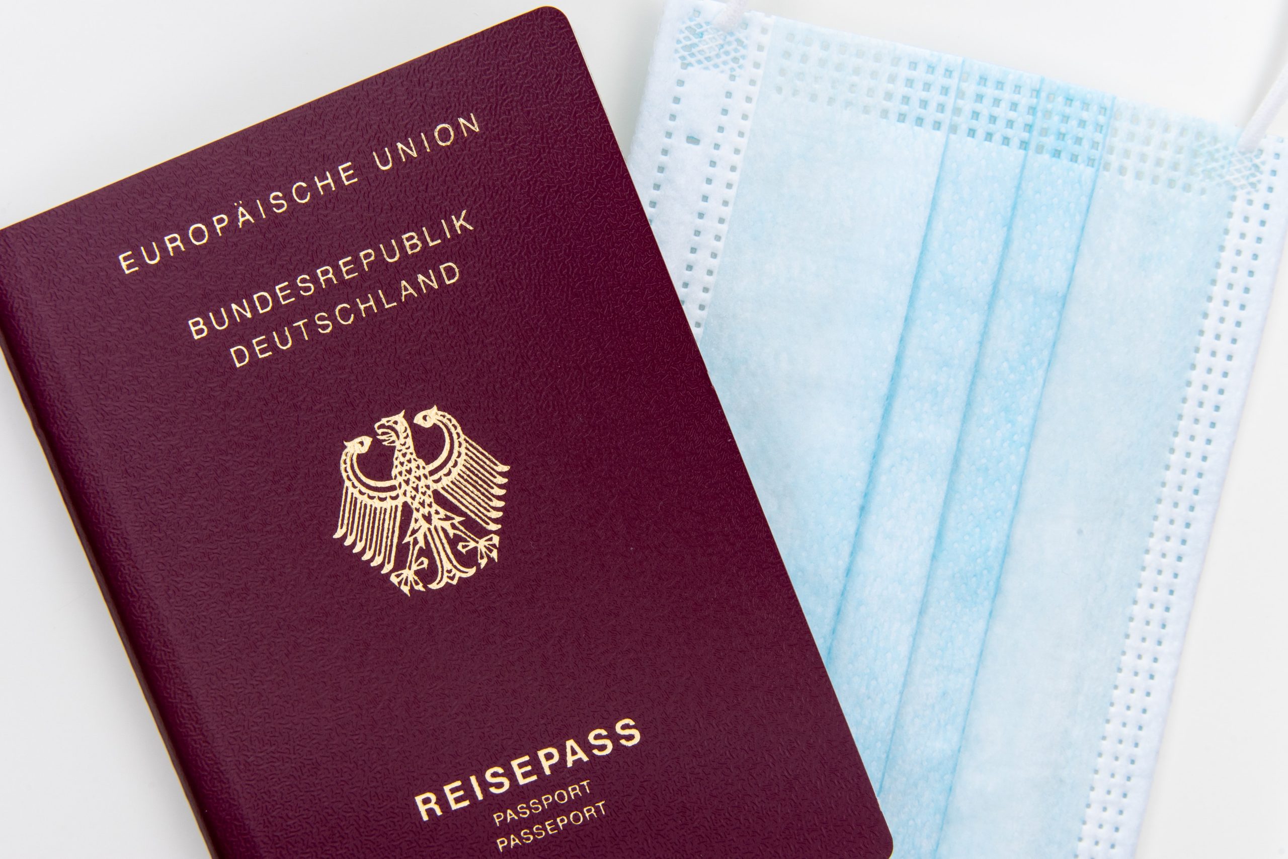 A close up of a passport and a face mask
