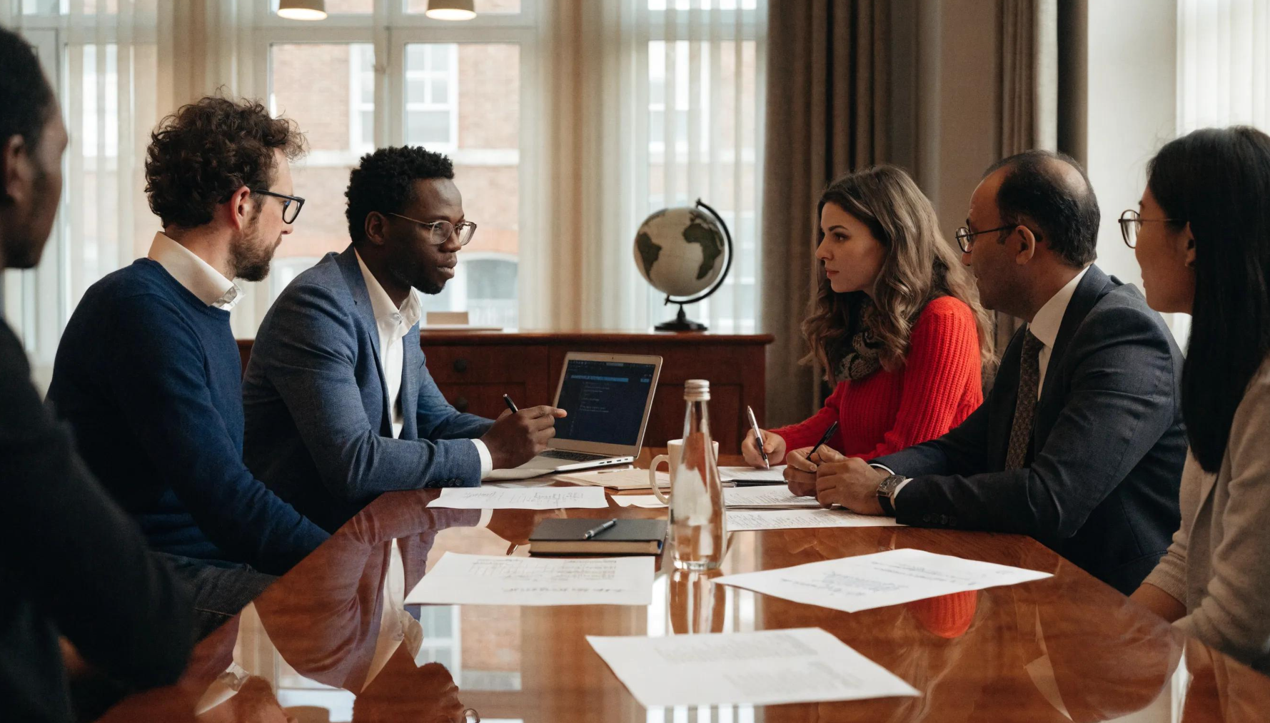 Business professionals engaged in cross-border due diligence discussions with international elements